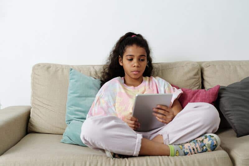 A girl reads a book in digital format