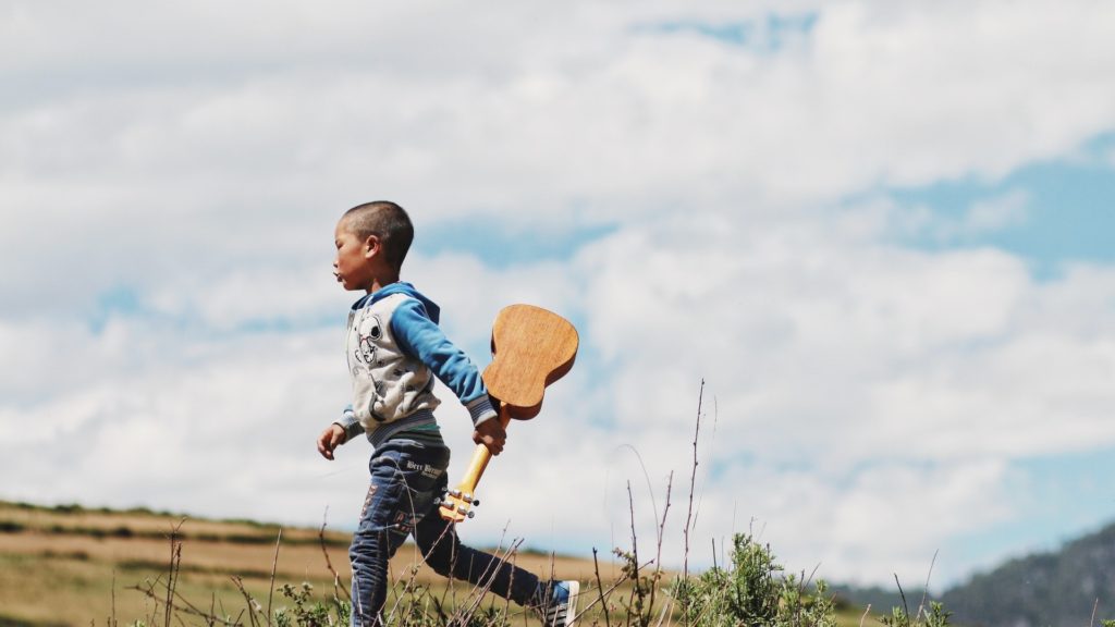 boy with ukulele learns music